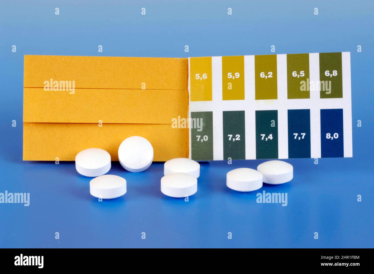 pH test strips acid-base balance and base tablets Stock Photo