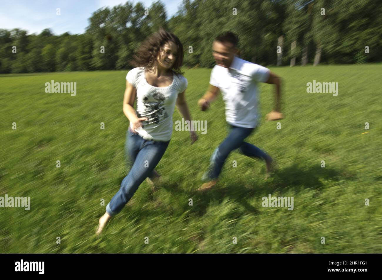 young couple clowning around in a meadow Stock Photo