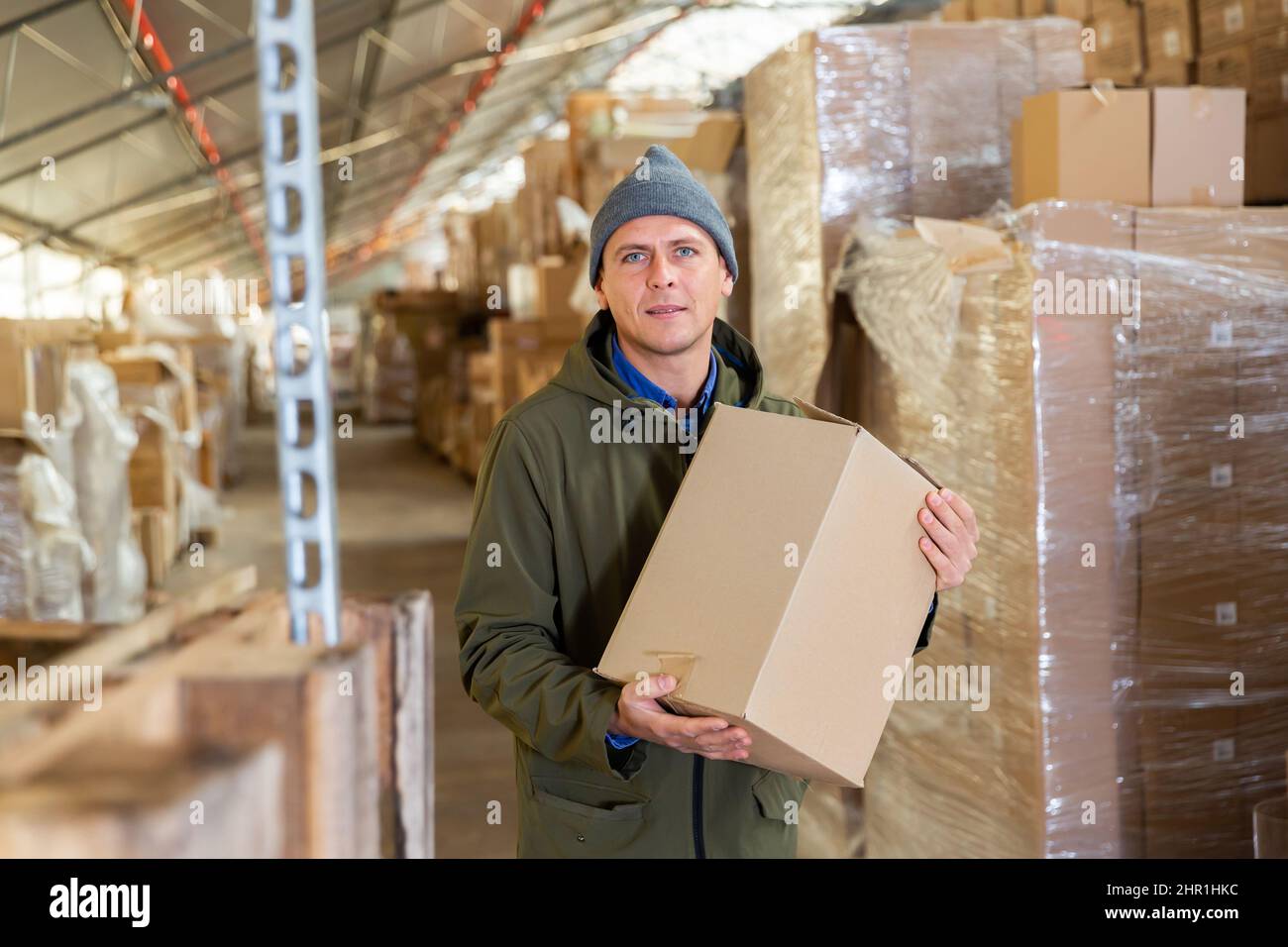 Warehouse worker with pasteboard box Stock Photo Alamy