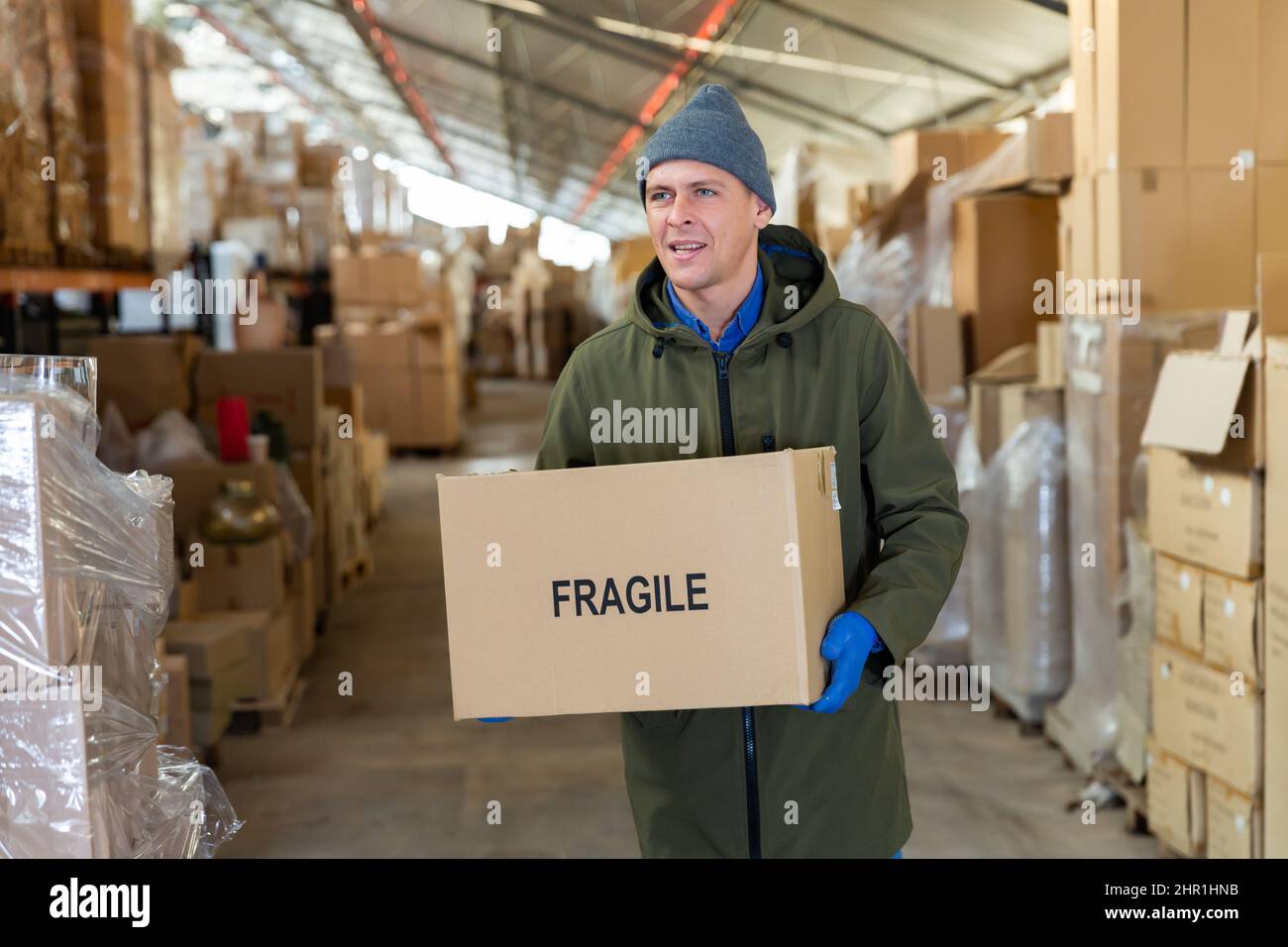 Storekeeper stacking pasteboard box in storehouse Stock Photo Alamy