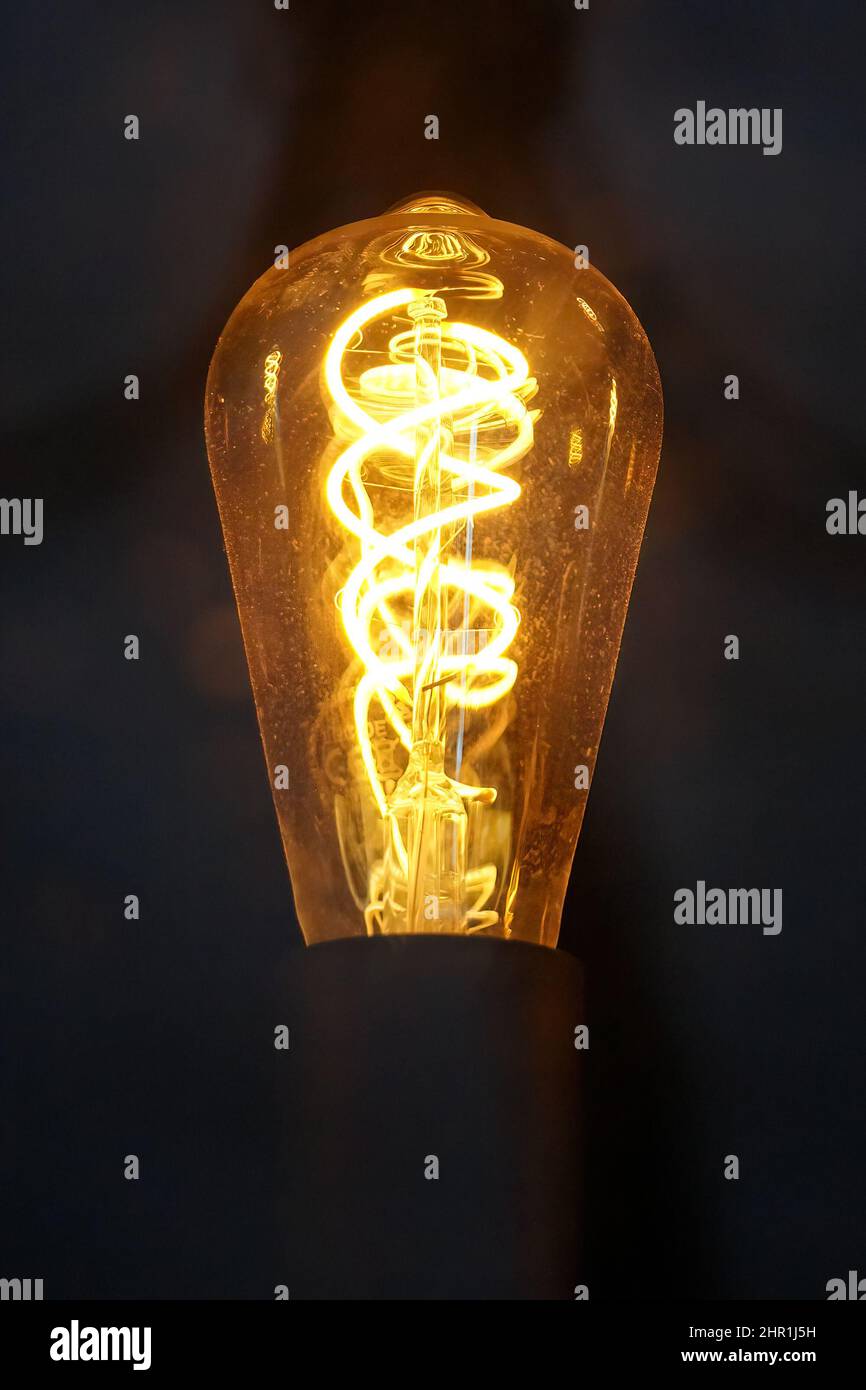 Old edison light bulb with glowing spiral Stock Photo Alamy