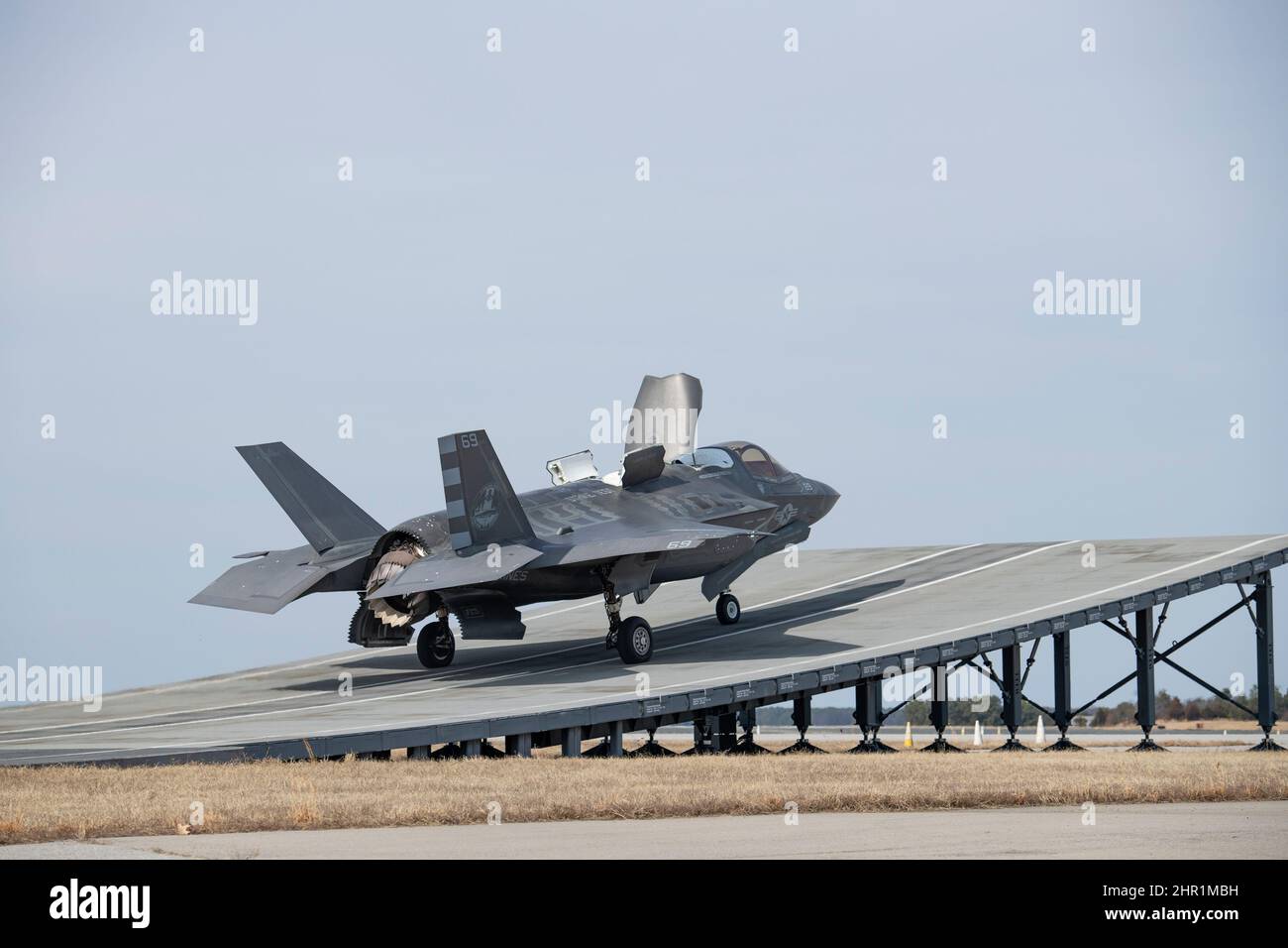Marine Maj. Dylan “Bilbo” Nicholas, test pilot, performs a short takeoff launch from a land-based ski jump in an F-35B Lightning II aircraft from the Patuxent River F-35 Integrated Test Force (ITF) at Naval Air Station Patuxent River, Md., Feb. 16, 2022. Flying the short takeoff vertical landing (STOVL) variant of the 5th generation fighter, Nicholas was participating in STOVL operations training for the combined test team – aircrew and flight test control room engineers. The Pax River ITF’s mission is to effectively plan, coordinate, and conduct safe, secure, and efficient flight test for F-3 Stock Photo