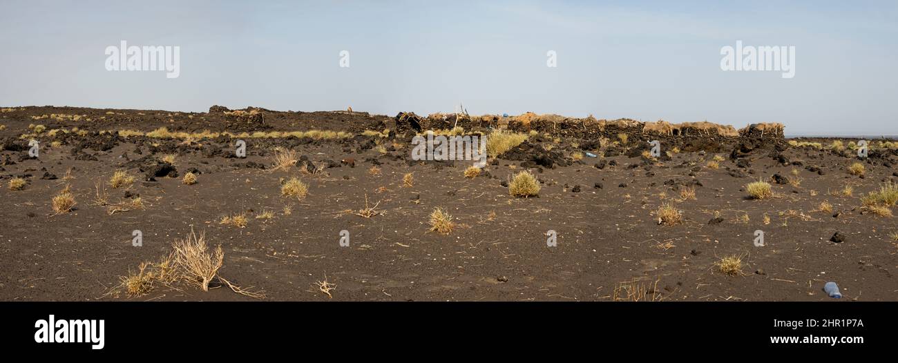 Landscape panorama view of traditional houses in front of Erta Ale Volcano in the remote regions of Ethiopia. Stock Photo