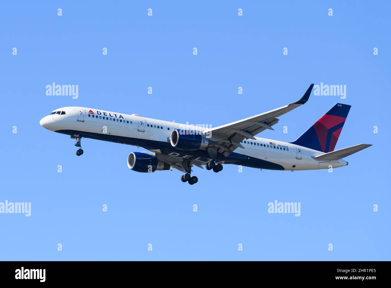 SeaTac, WA, USA - February 23, 2022;Delta Air Lines boeing 757 landing isolated against blue sky with wheels down Stock Photo