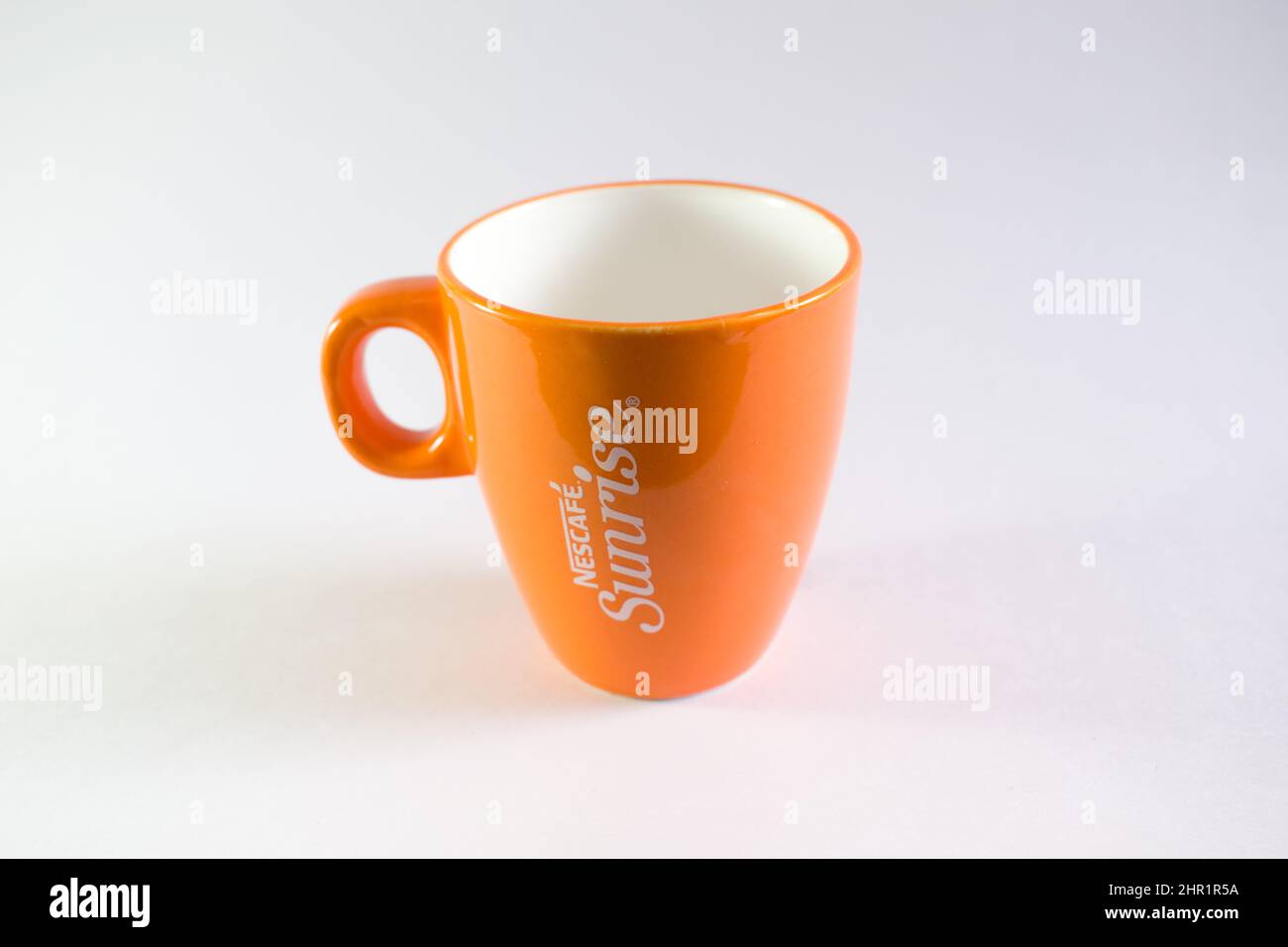 https://c8.alamy.com/comp/2HR1R5A/a-picture-of-an-orange-cup-of-nescafe-sunrise-in-white-background-2HR1R5A.jpg