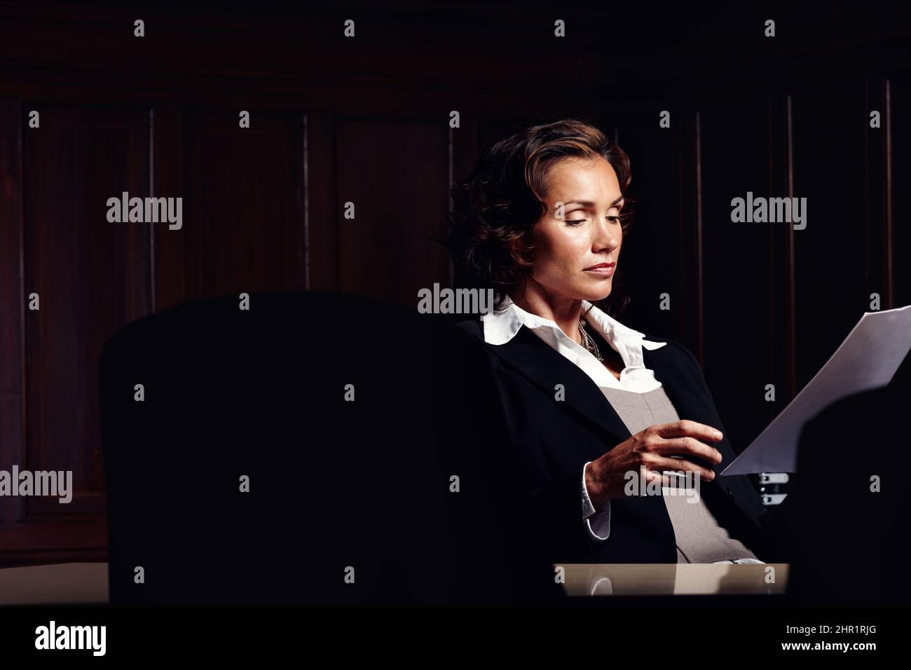 Preparing legal documents. Attractive mature legal woman reading