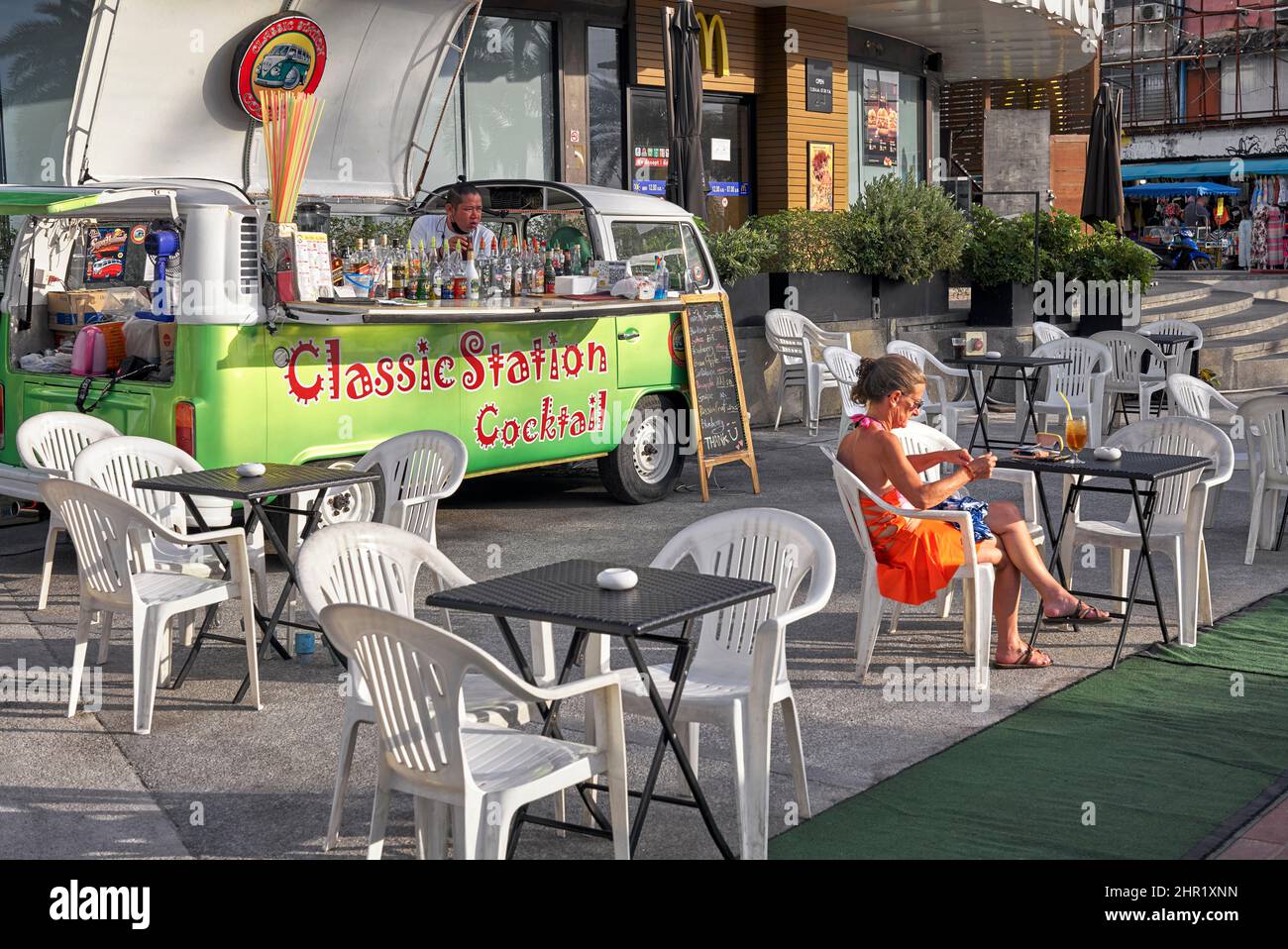 Woman drinking alcohol, alone outside, mobile cocktail bar. Thailand Southeast Asia Stock Photo