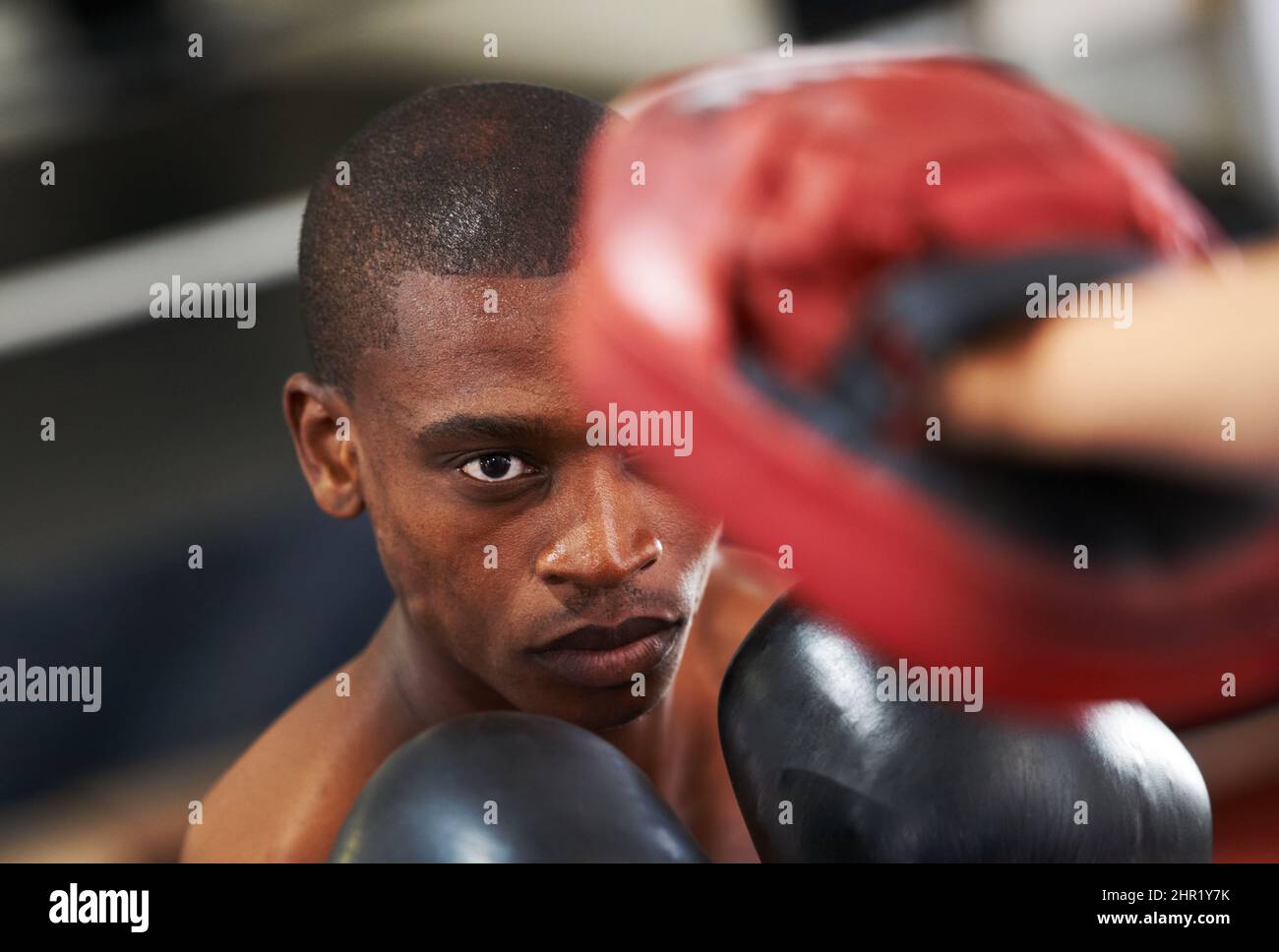 Eyes up here. A young boxer throwing a punch at his partners sparring