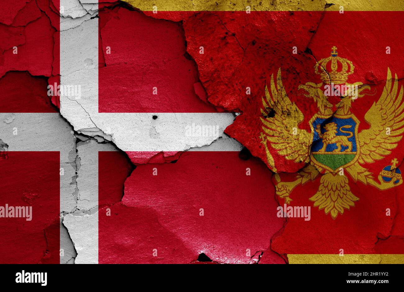 flags of Denmark and Montenegro painted on cracked wall Stock Photo