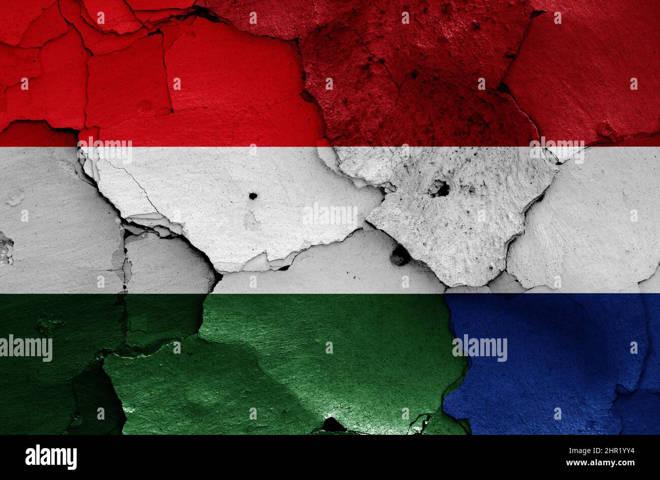 flags of Hungary and Netherlands painted on cracked wall Stock Photo