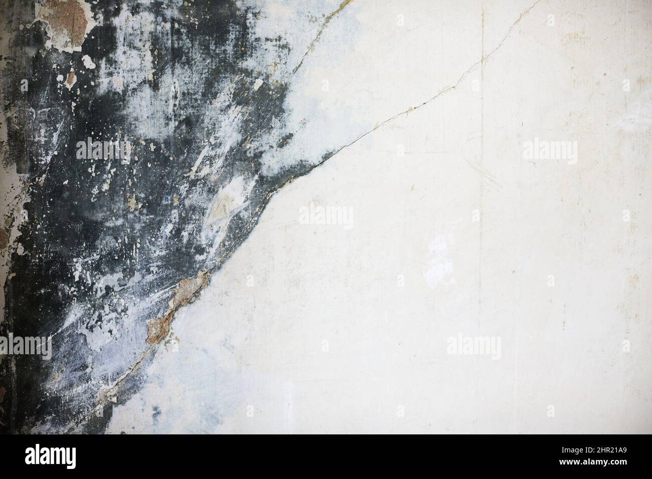 The texture of the concrete wall with partially washed away plaster