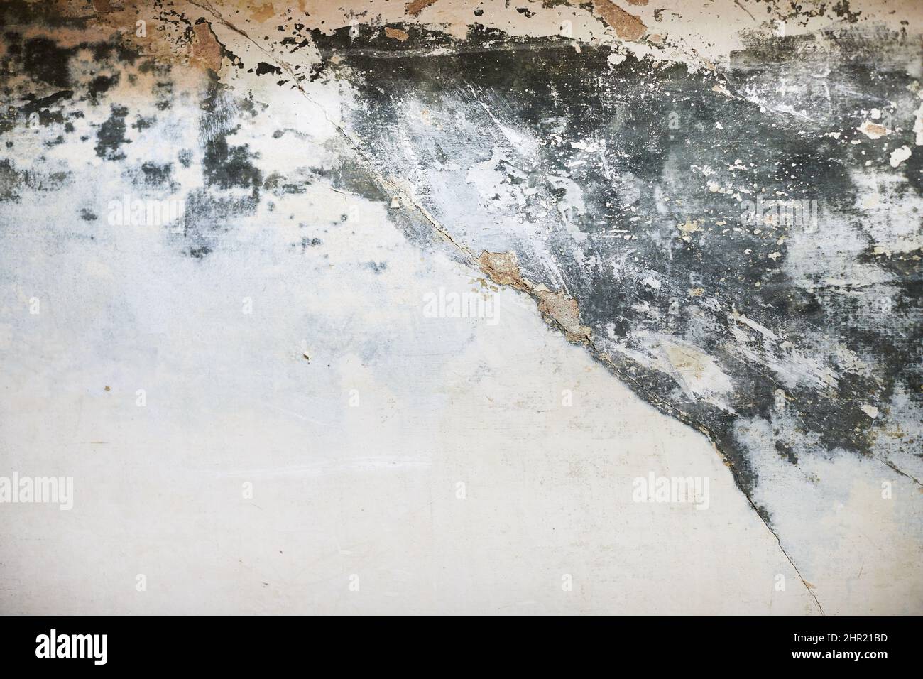 The texture of the concrete wall with partially washed away plaster