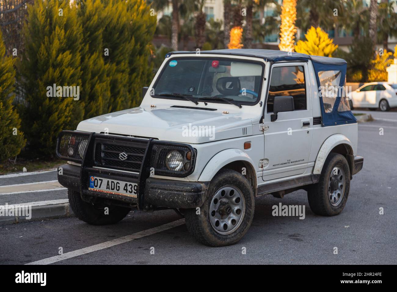 Side, Turkey – February 02 2022: white Suzuki Safari  is parked  on the street on a warm  day against the backdrop of a buildung, park Stock Photo