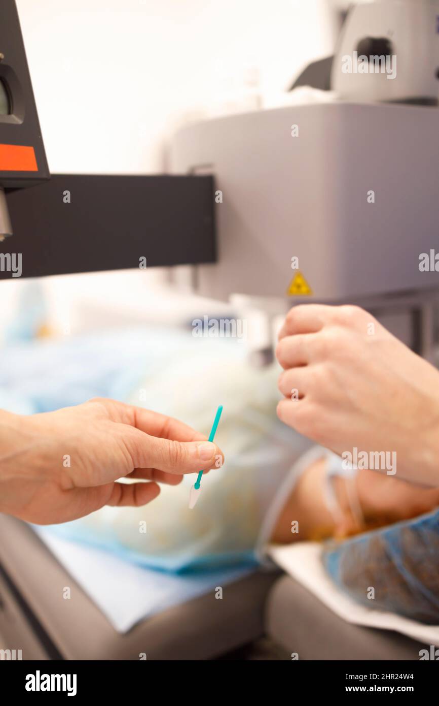 Detail of a nurse handing out equipment during a surgery Stock Photo