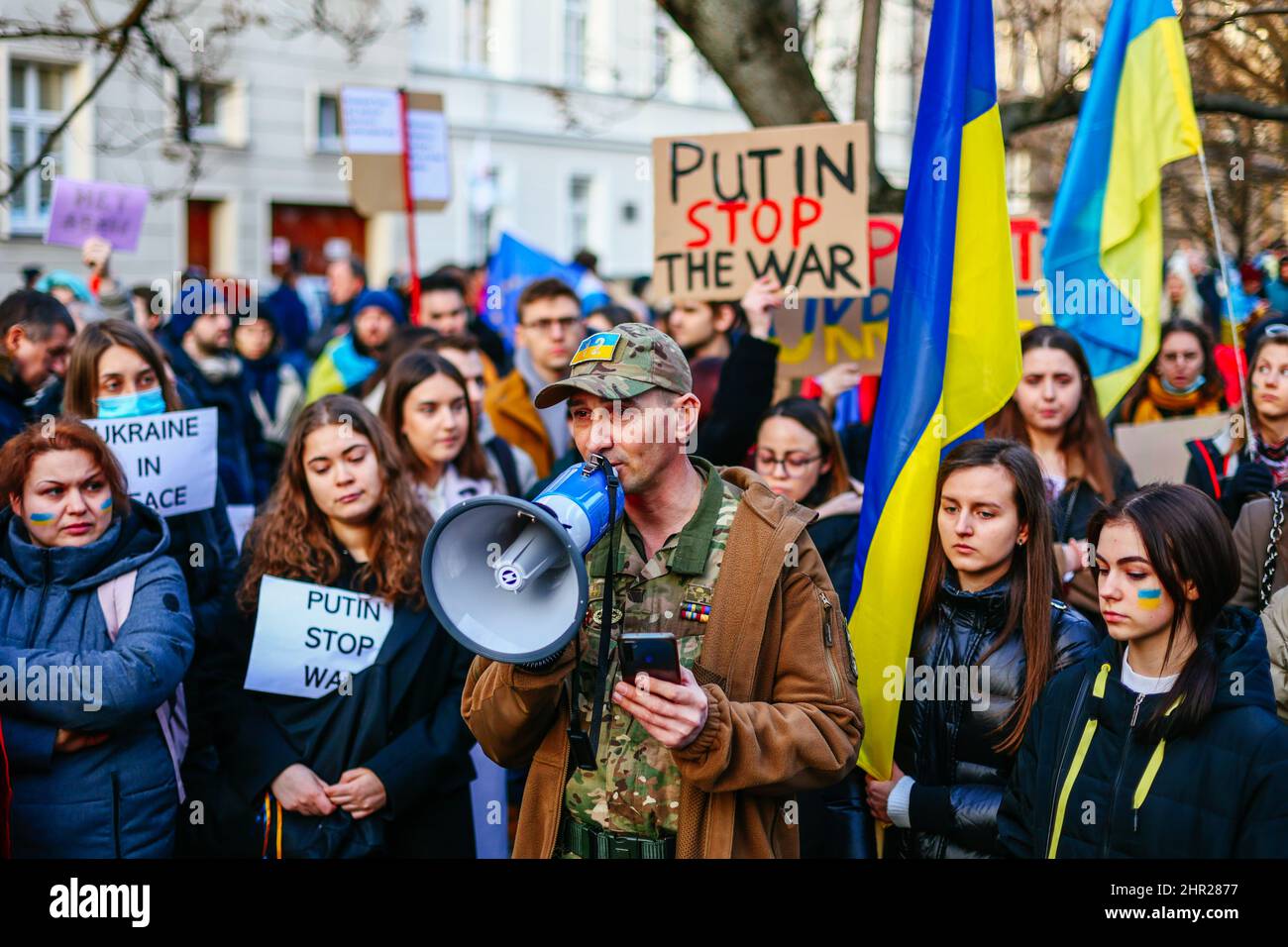 A veteran of Ukrainian army speaks to the crowd using a bullhorn during the protest.  Following the beginning of the Russian invasion of Ukraine, memb Stock Photo