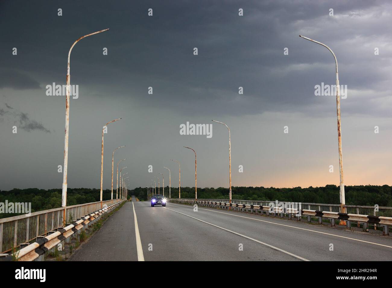 Ukraine, in the restricted and uninhabitable 30 kilometer zone around the Chernobyl power plant and the Pripyat labor camp, bridge during thunderstorm Stock Photo