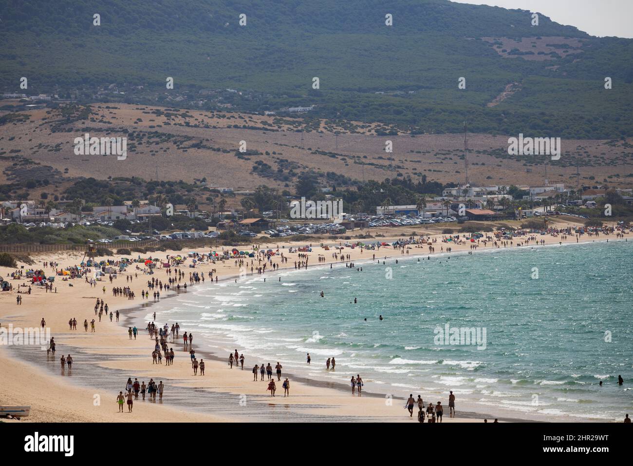 Tarifa, Spain- july 29 2021. People walking in  Playa de Bolonia, one of the white sandy beach of Tarifa, Cádiz. Andalucía, Spain Stock Photo