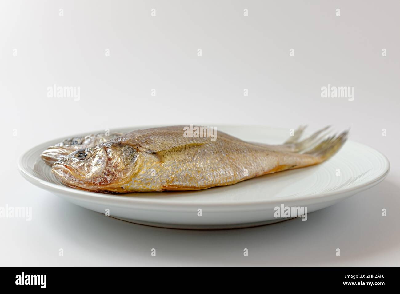 dried yellow croaker on a white background Stock Photo