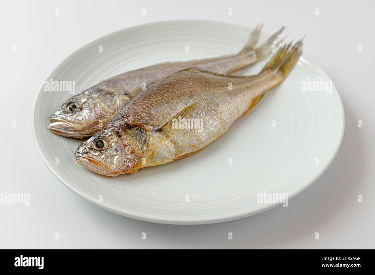 dried yellow croaker on a white background Stock Photo
