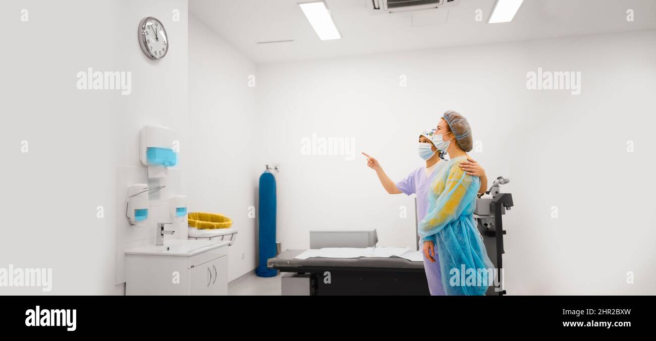 Female patient and her doctor looking at a watch as a post-operative procedure for the diopter laser removal Stock Photo