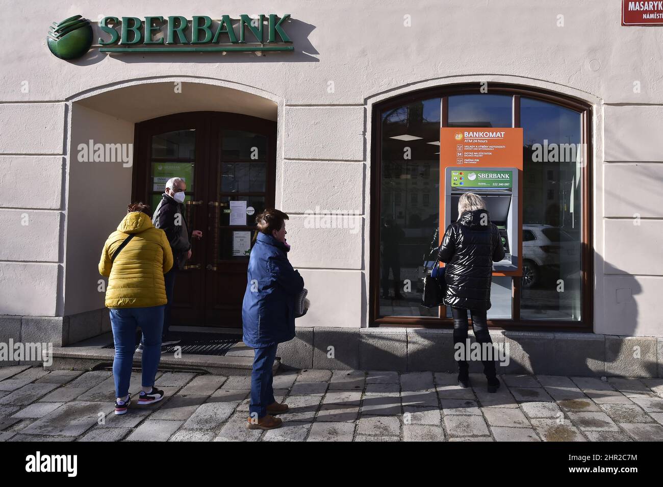 Jihlava, Czech Republic. 25th Feb, 2022. People are seen outside the branch of Russian bank Sberbank in Jihlava, Czech Republic, on February 25, 2022. In connection with the Russian army's attack on Ukraine, US President Joe Biden announced economic sanctions against Russian banks Sberbank and VTB. Credit: Lubos Pavlicek/CTK Photo/Alamy Live News Stock Photo