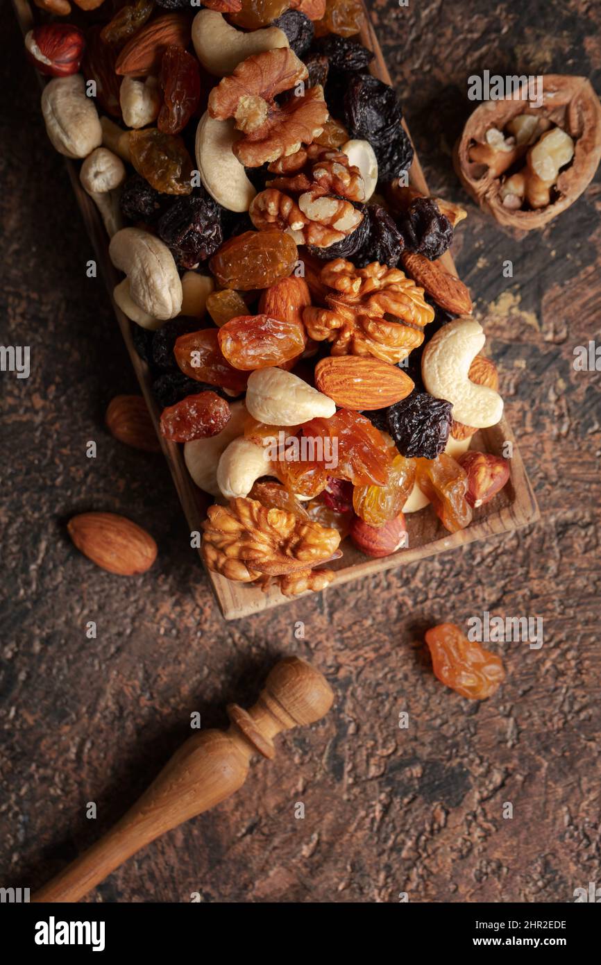 Mix of nuts and raisins on a brown rustic background. Presented raisins
