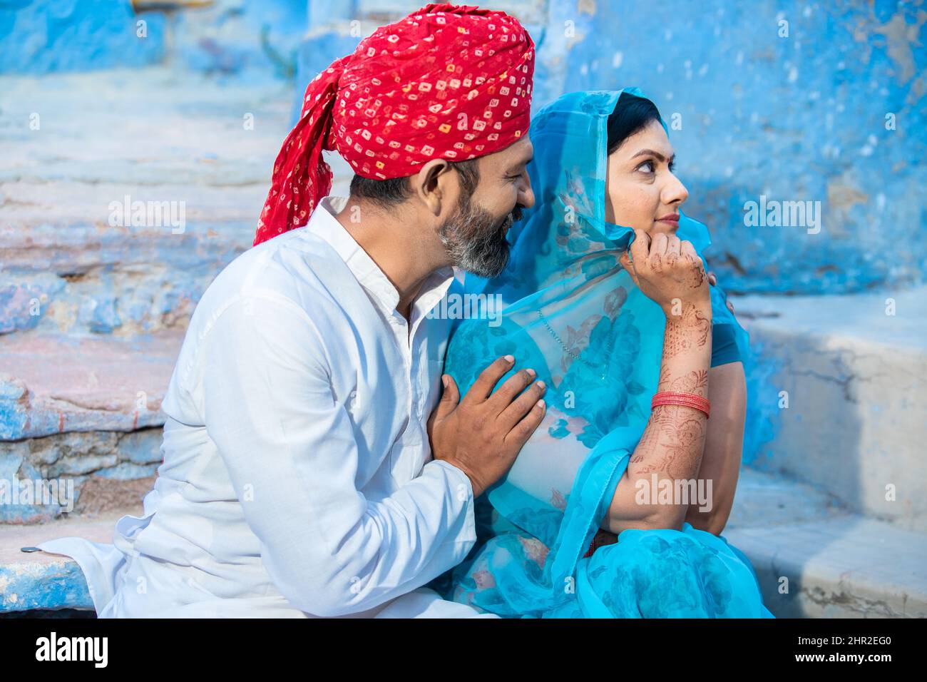 Indian wife wearing sari upset with her husband, man show support to to unhappy offended woman, caring man make peace and reconcile with lover, family Stock Photo