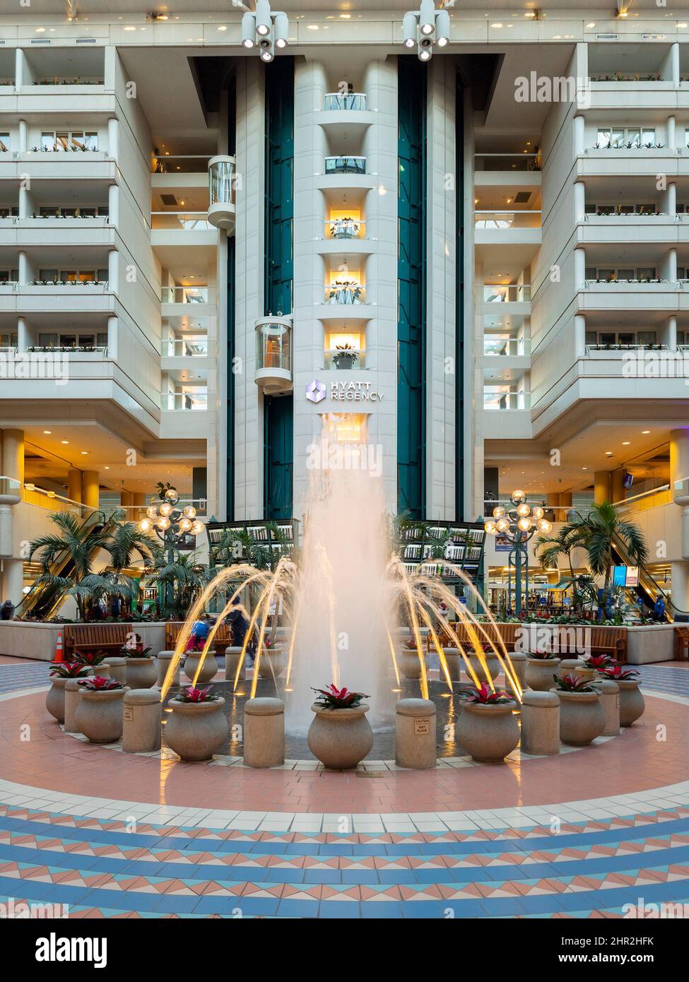 Orlando, Florida - February 9, 2022: Vertical View of Terminal B Main Hall inside Orlando International Airport (MCO) with Fountain in Foreground and Stock Photo