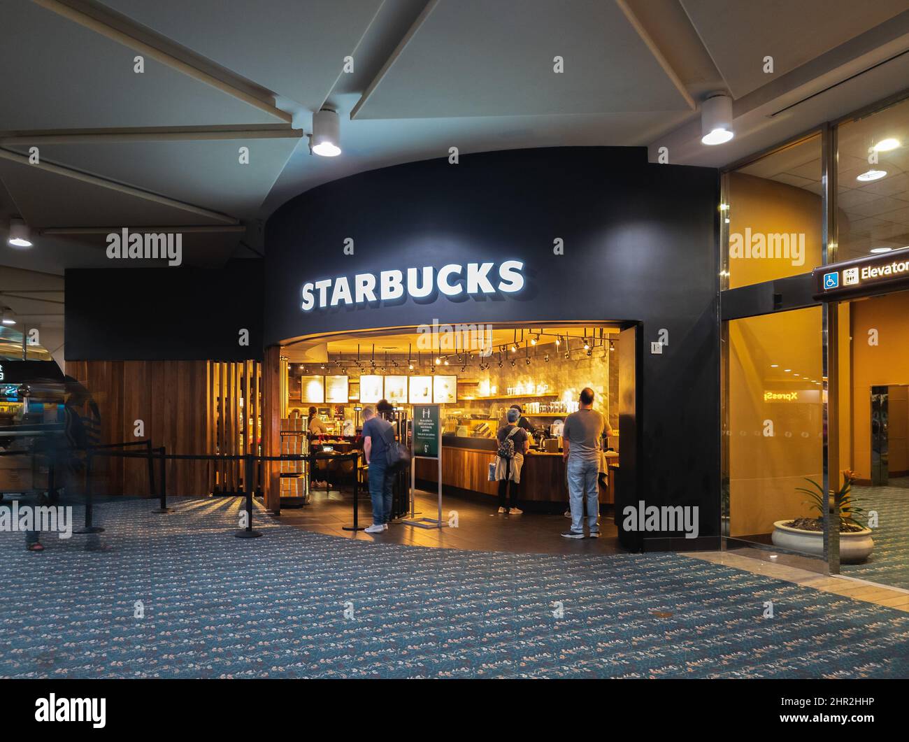 Orlando, Florida - February 4, 2022: Long Exposure View of Starbucks Coffee Shop inside Terminal B of Orlando International Airport. Stock Photo