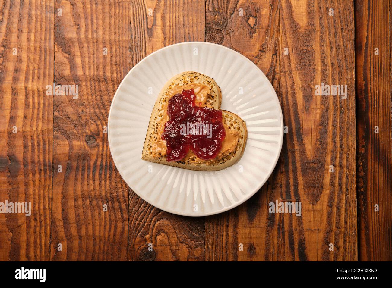 A valentines heart shaped crumpet with peanut butter and jelly jam. Stock Photo