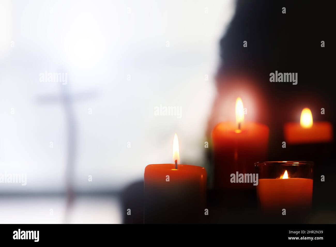 Beautifully shining Christmas decorations, candles and the holy cross