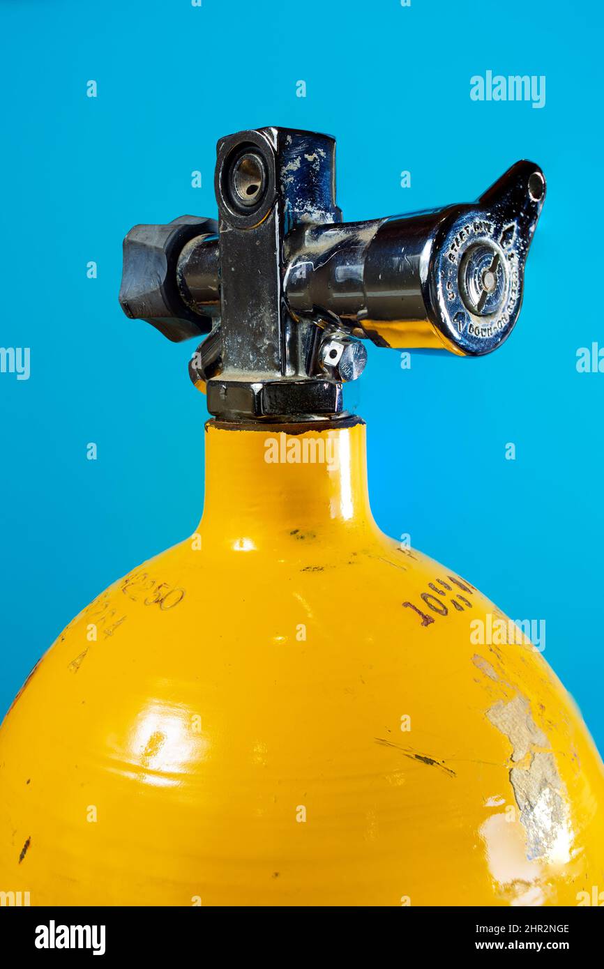 J valve in the reserve position on a vintage yellow steel scuba tank