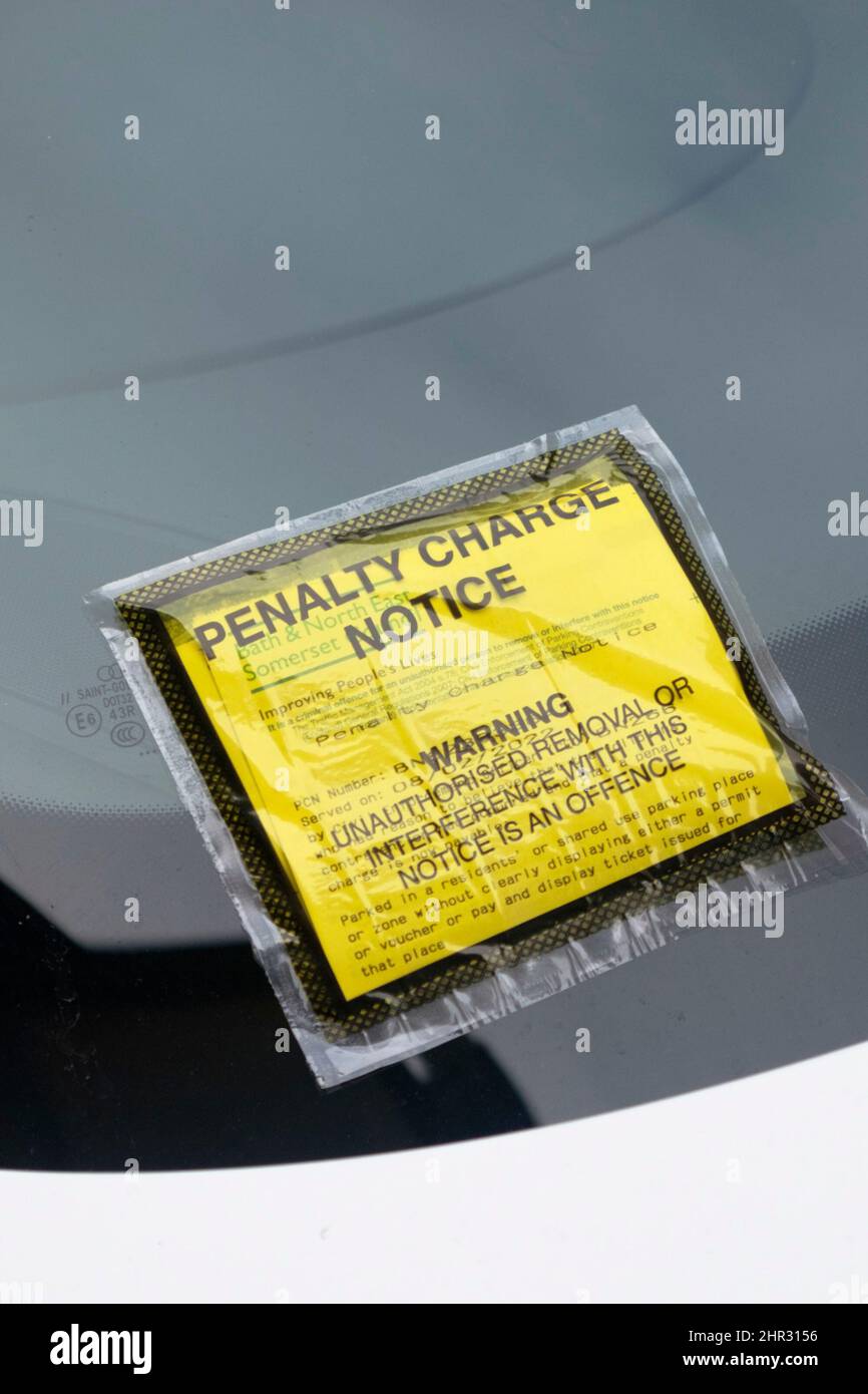 A parking ticket or fixed penalty charge notice on a car windscreen Stock Photo