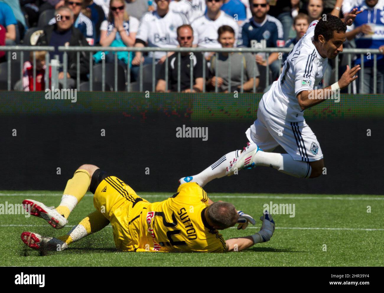 New York Red Bulls goalie Greg Sutton, left, stops Vancouver Whitecaps ...