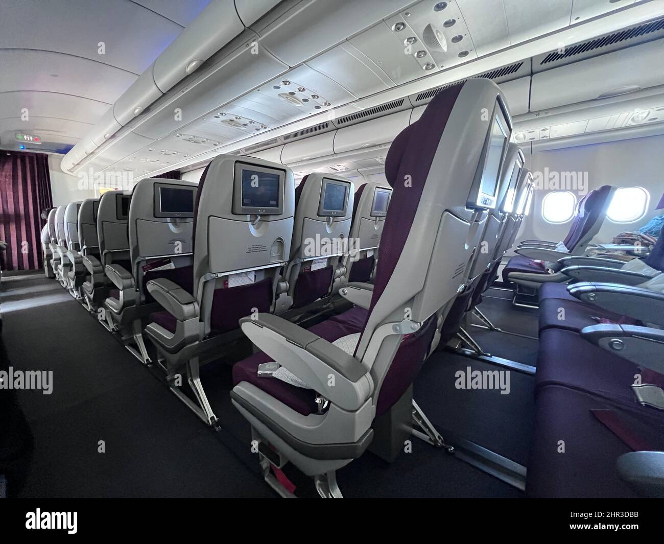 Rows of open seats on Qatar Air flight Stock Photo