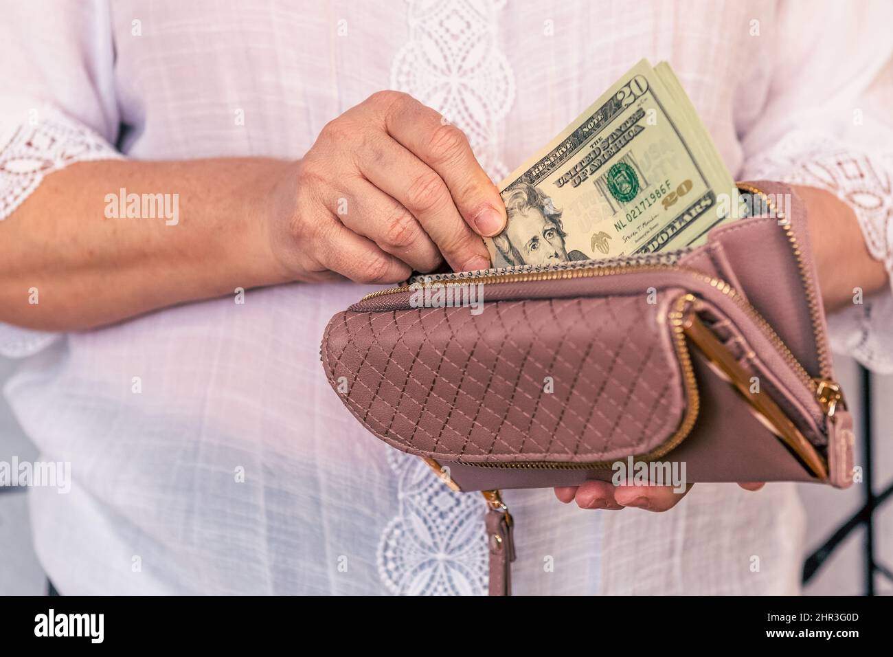 hand of a woman saving money Stock Photo