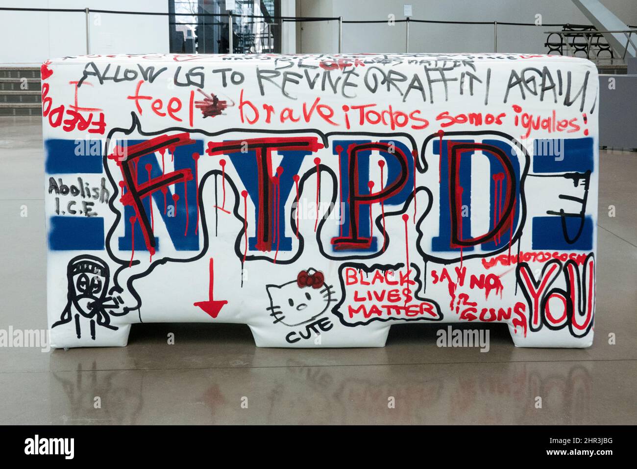 A plywood and foam imitation of an NYPD police barrier that viewers are invited to write on. At the Queens Museum in Flushing Meadows Corona Park, NYC Stock Photo