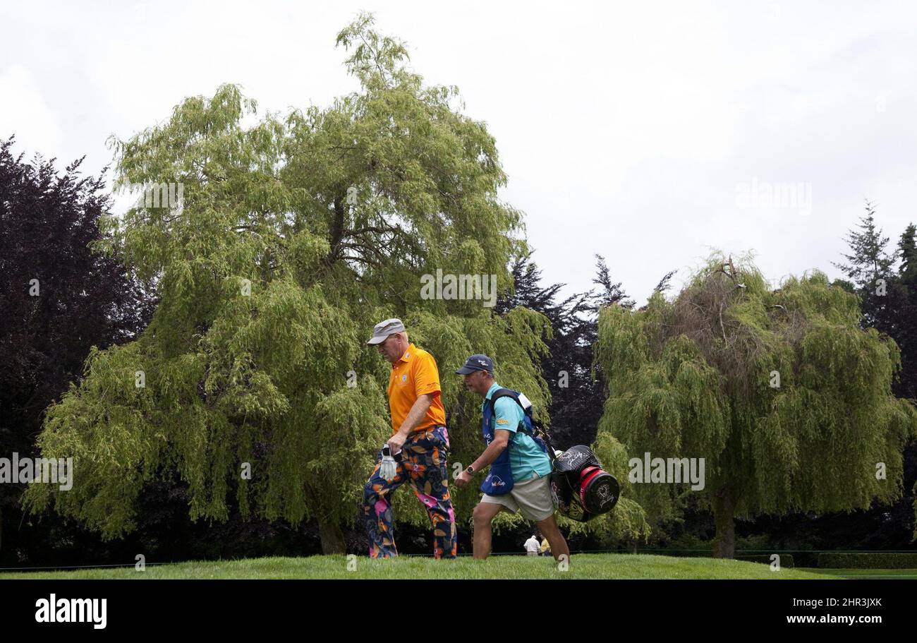 John Daly walks up the sixth fairway with his caddy during the ProAm