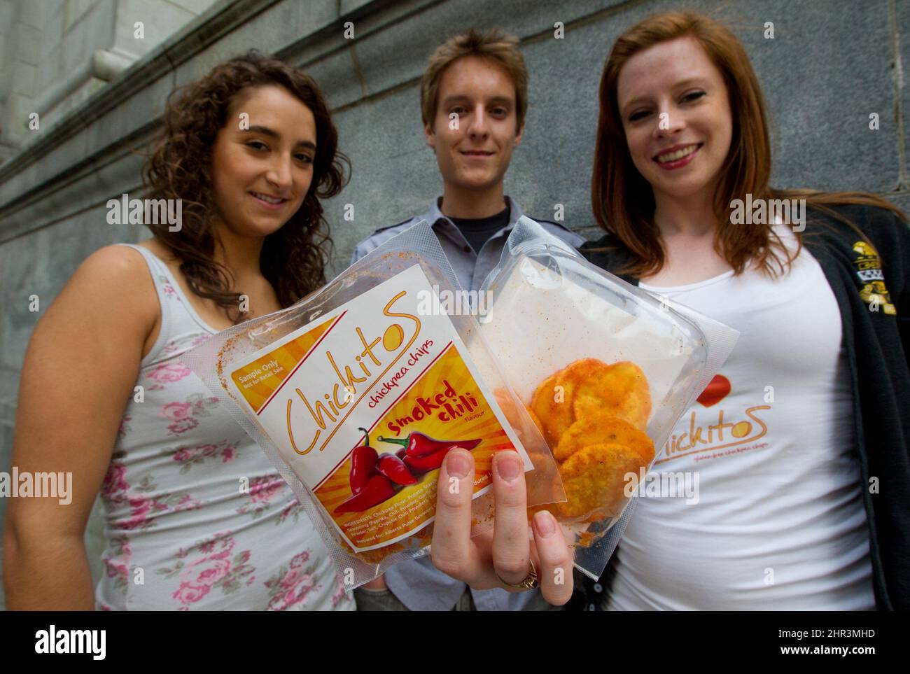 Kate Alexander, right, stands with team members Paula Duenas, left, and