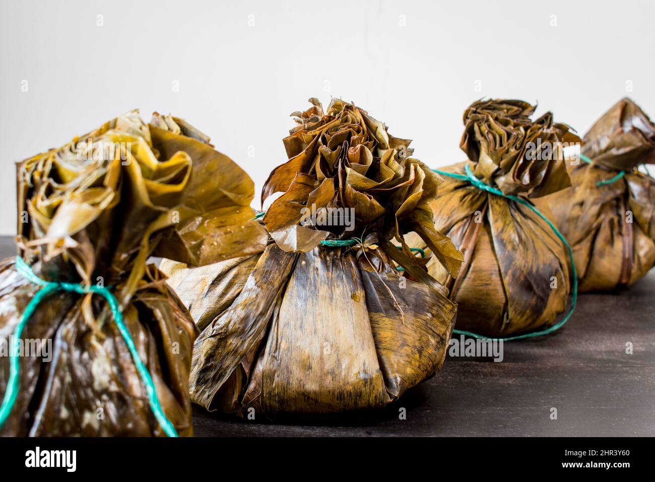 Traditional Colombian food known as "tamales" wrapped with leaves Stock