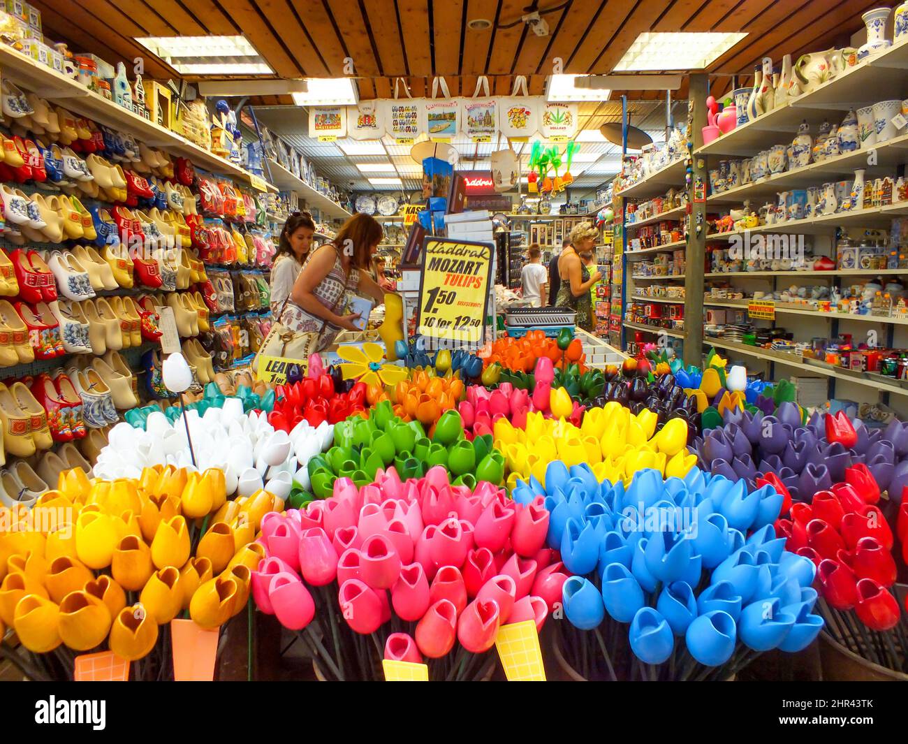 Amsterdam - May 1, 2014, Souvenir shop in Amsterdam, Holland, Netherlands, Colorful Tulips, Flower store, Mozart Tulips, people are shopping, Clogs Stock Photo