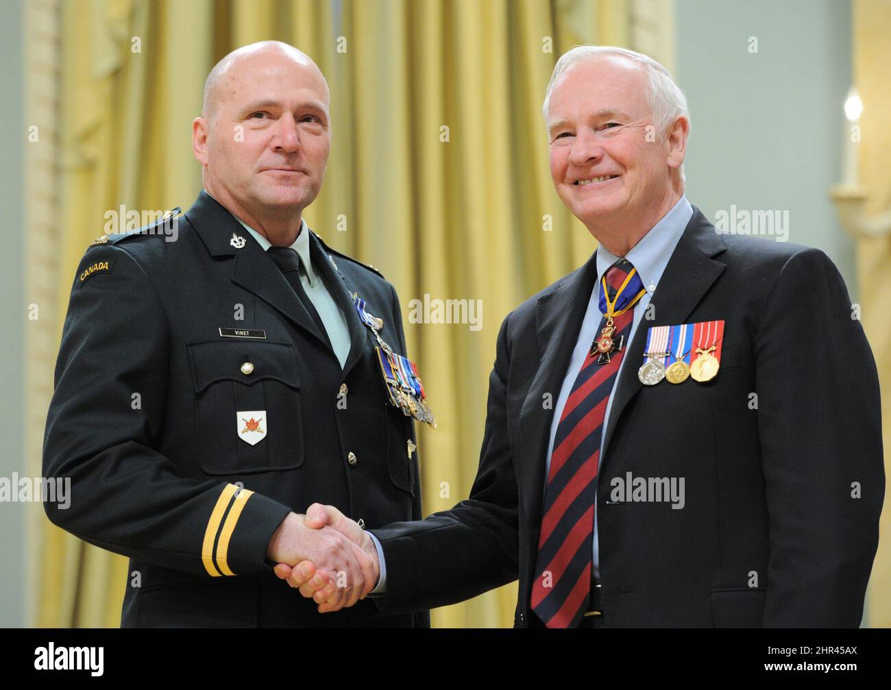 Governor General David Johnston presents the Meritorious Service Cross to Chief Warrant Officer Joseph Simon Armand Vinet during a ceremony at Rideau Hall in Ottawa on Thursday, January 26, 2012. Vinet has since been promoted to Captain. (AP Photo/The Canadian Press, Sean Kilpatrick) Stock Photo