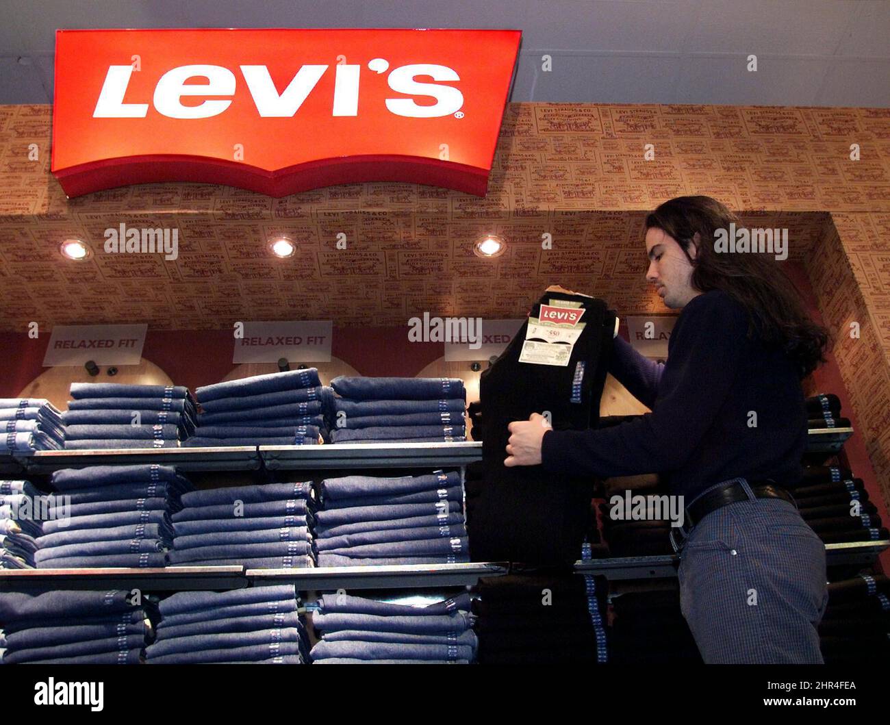 Store employee Brett Mitsobata stocks a 