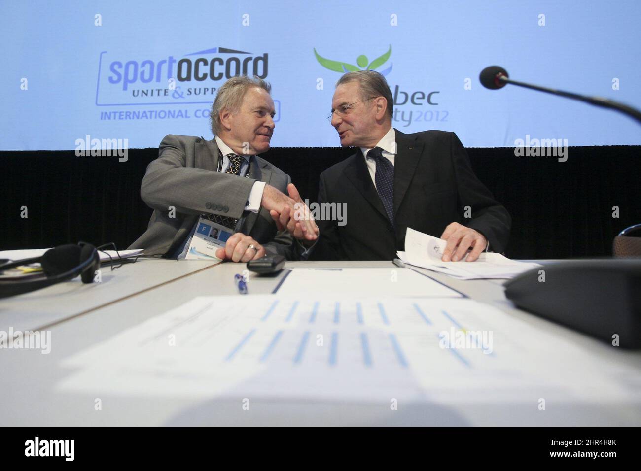 Denis Oswald, left, member of the International Olympic Committee executive board, and Jacques Rogge, president of IOC, shake hands before the beginning of a joint meeting of the IOC Executive Board and the Summer Olympic International Federation at the SportAccord conference in Quebec City Wednesday, May 23, 2012. SportAccord promotes communication and cooperation among various international sports federations. (AP Photo/The Canadian Press, Francis Vachon) Stock Photo