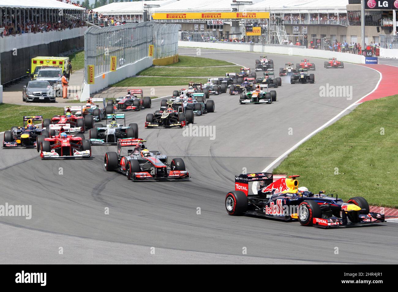 Red Bull Racing driver Sebastian Vettel, from Germany, leads the pack into the first turn at the start of Formula One's Montreal Grand Prix auto race on Sunday, June 10, 2012. (AP Photo/The Canadian Press, Ryan Remiorz) Stock Photo