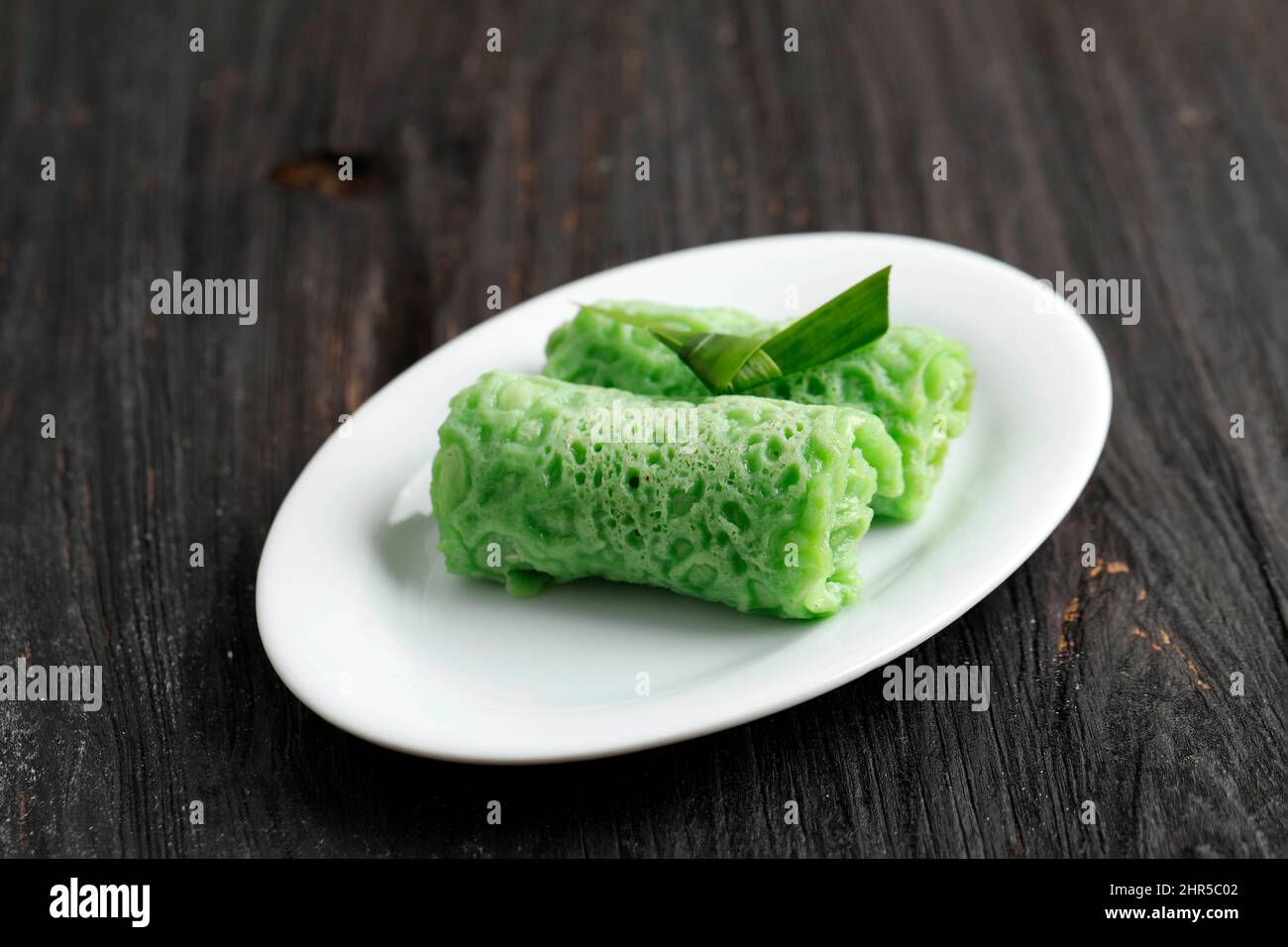 Dadar gulung or Ketayap or Pancake is Traditional Cake Made From Flour, Filled with Grated Coconut, and Palm Sugar. Popular snack in Indonesia, Malays Stock Photo