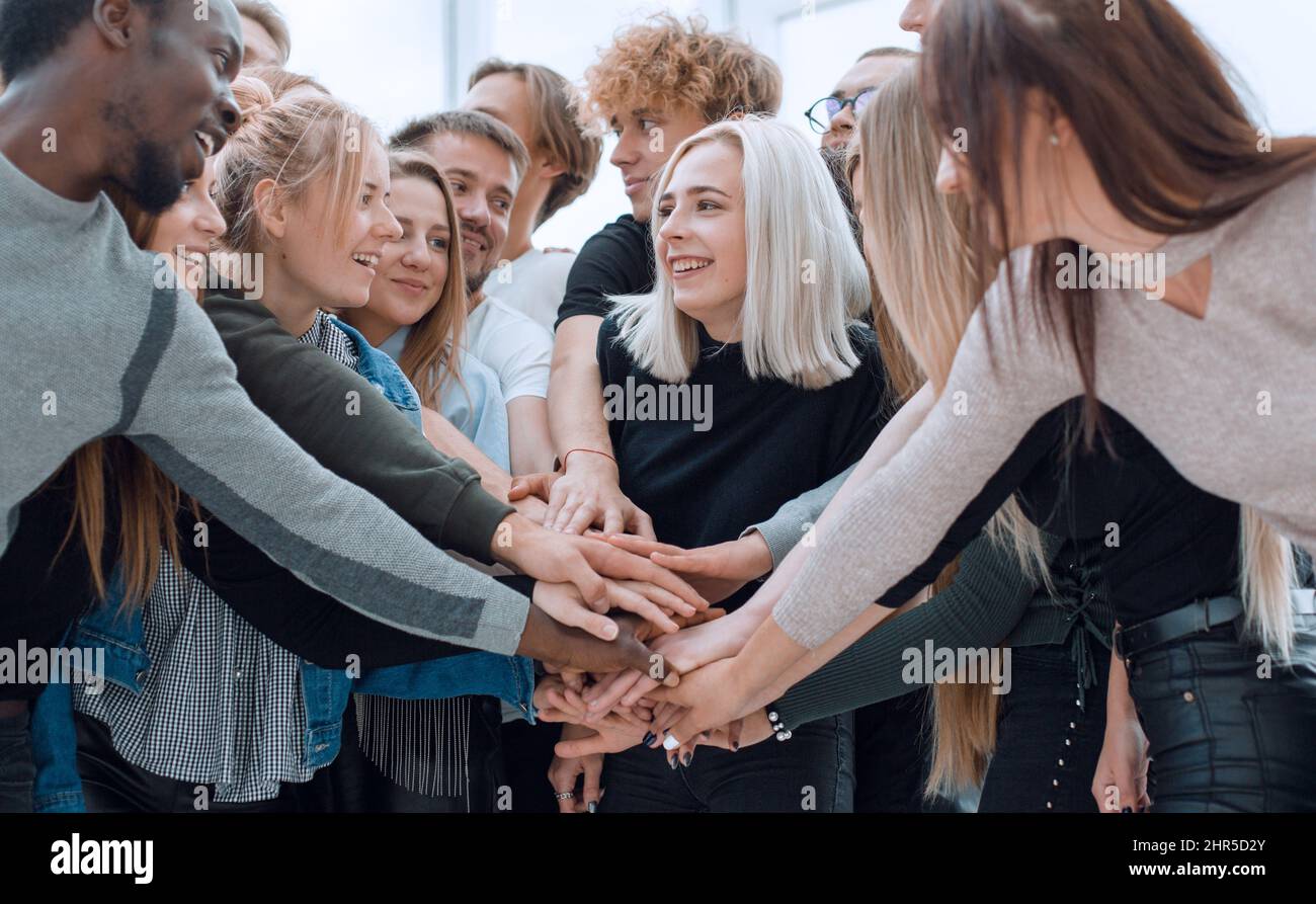 diverse young people putting their hands together Stock Photo - Alamy