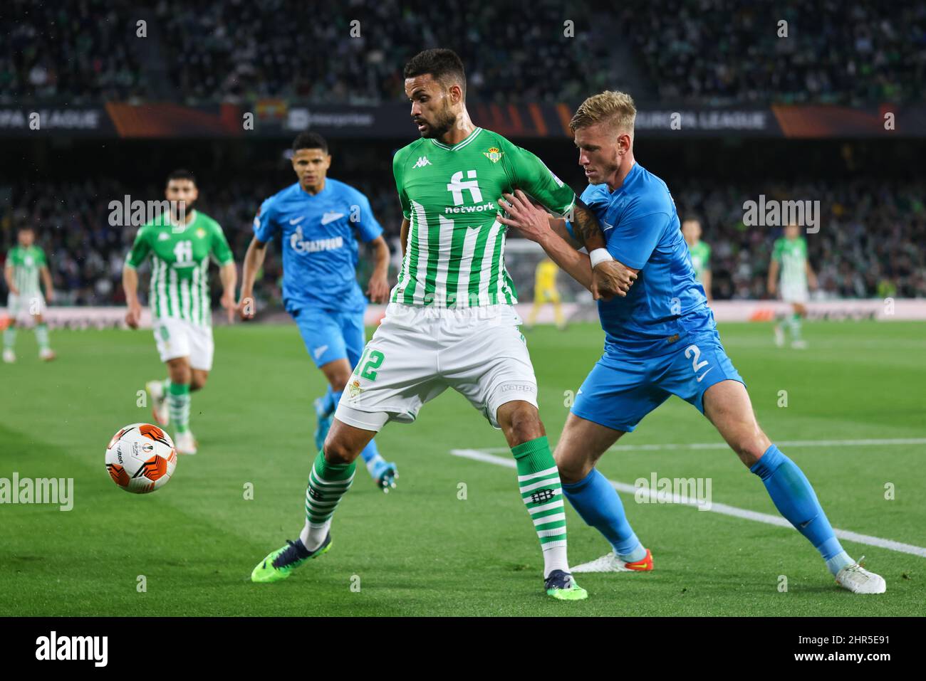 Seville, Seville, Spain. 24th Feb, 2022. Willian Jose of Real Betis in action with Dmitri Chistyakov of Zenit St. Petersburg during the UEFA Europa League Round Play-Offs Leg One match between Real Betis and Zenit St. Petersburg at Benito Villamarin Stadium on February 24, 2022 in Seville, Spain. (Credit Image: © Jose Luis Contreras/DAX via ZUMA Press Wire) Stock Photo