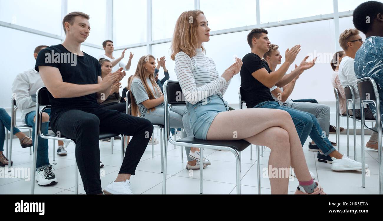 group of young people sitting in a bright conference room Stock Photo ...