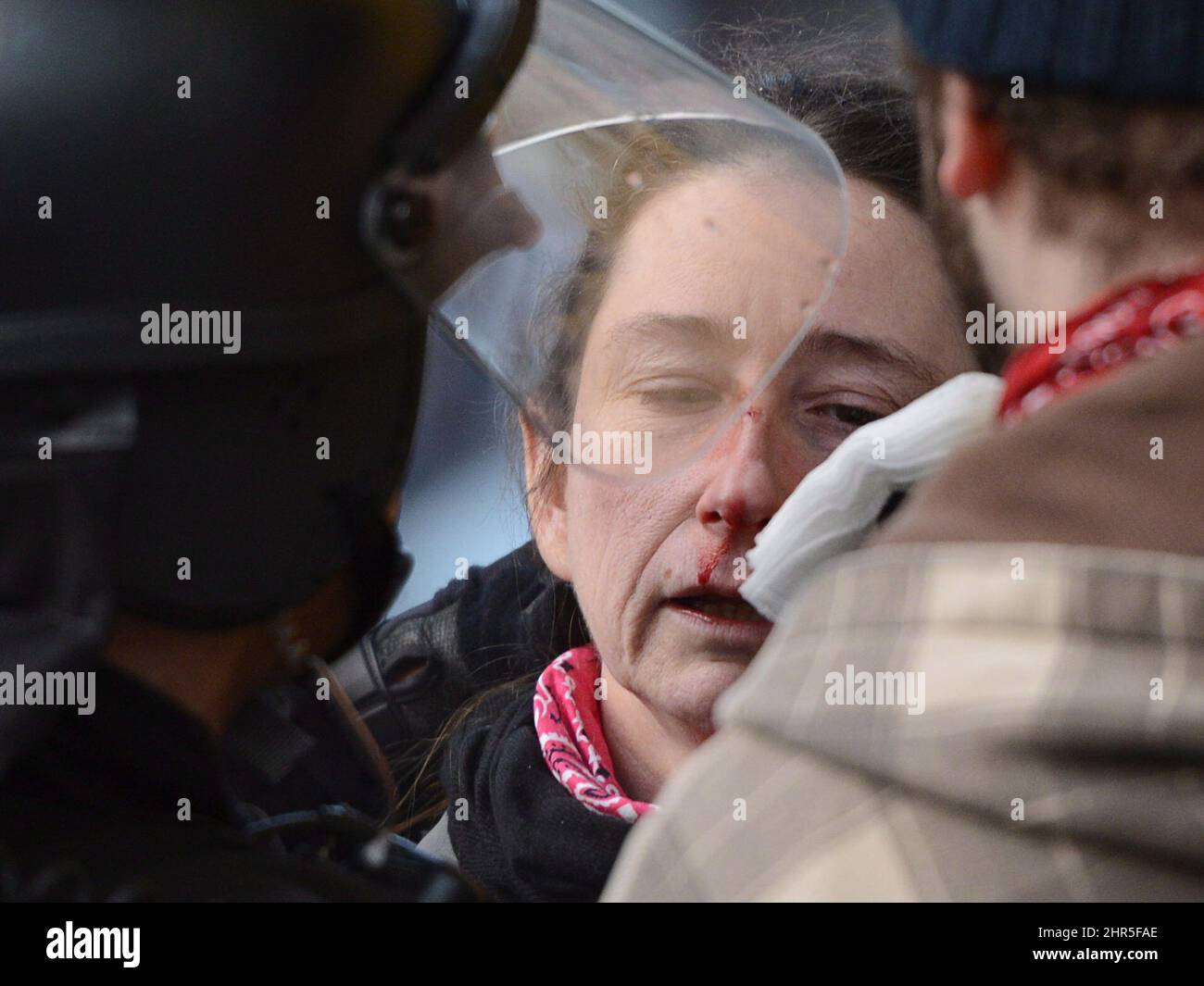 A woman is helped during an anti-police brutality demonstration in Montreal on Friday March 15, 2013. Police used horses, pepper-spray and kettling tactics to clamp down Friday on an annual protest that has a history of getting rowdy.THE CANADIAN PRESS/Ryan Remiorz Stock Photo